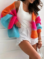 Candy Cloud Cardigan – oversized color block knit in orange, pink, blue, and contrasting tones.